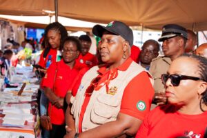 Minister of Health Hon. Khumbize Kandodo Chiponda listening to student ambassadors at a Pamodzi project pavilion.