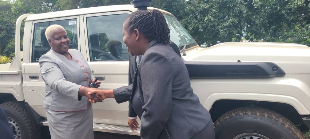 Hon. Khumbize Kandodo Chiponda hands over car keys to Mrs. Emily Kayimba for community systems strengthening